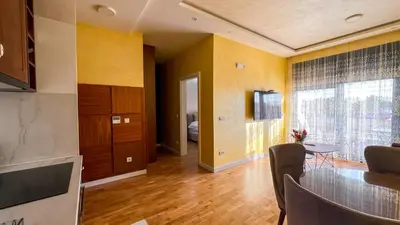 a kitchen with a table and a dining room at Harmony Apartment 2 in Bar