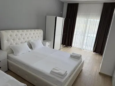 a bedroom with a large white bed with two pillows at Apartments Paris in Donji Štoj