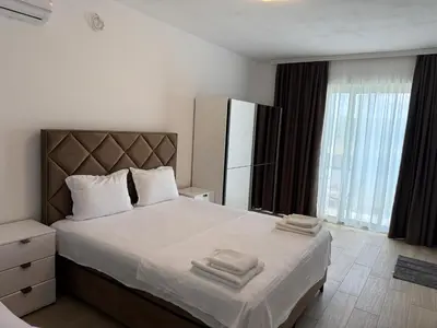 a bedroom with a large bed with towels on it at Apartments Paris in Donji Štoj