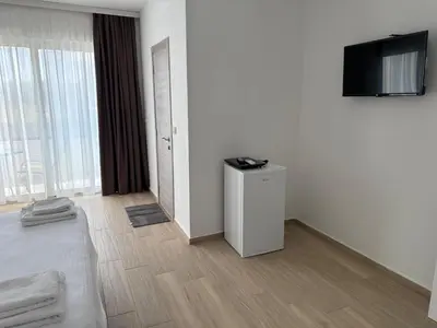 a white room with a television and a bed at Apartments Paris in Donji Štoj