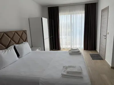 a bedroom with a large bed with two towels on it at Apartments Paris in Donji Štoj