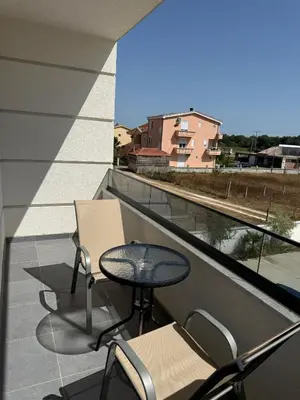 a balcony with a table and chairs and a view at Apartments Paris in Donji Štoj
