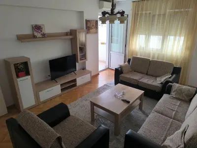 a living room with two couches and a tv at TriKula Nest in Bar