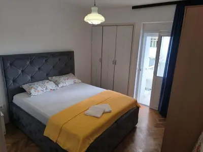 a bedroom with a bed with a yellow blanket at TriKula Nest in Bar