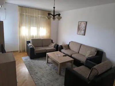 a living room with two couches and a coffee table at TriKula Nest in Bar