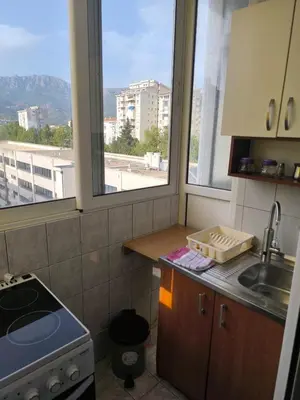 a kitchen with two windows and a sink and a stove at TriKula Nest in Bar