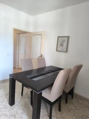 a dining room table with chairs and a black table at TriKula Nest in Bar