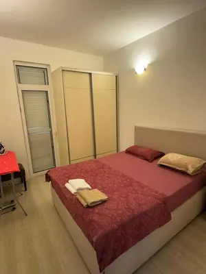 a bedroom with a bed with towels on it at Apartman Itana Budva in Budva