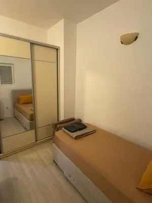 a bedroom with a bed and a large mirror at Apartman Itana Budva in Budva