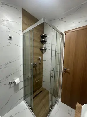 a shower with a glass door in a bathroom at Modern Apartments Two Pearls in Budva