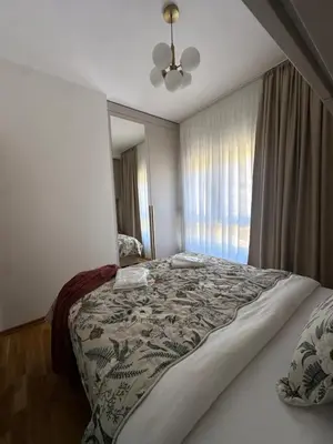a bedroom with a large bed and a window at Modern Apartments Two Pearls in Budva