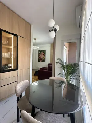 a dining room with a glass table and chairs at Modern Apartments Two Pearls in Budva