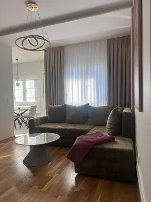 a living room with a couch and a table at Modern Apartments Two Pearls in Budva