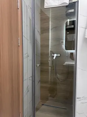 a shower with a glass door in a bathroom at Modern Apartments Two Pearls in Budva