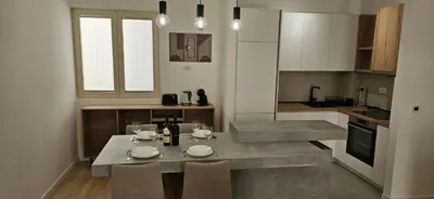 a kitchen with a table and chairs in a kitchen at ROYAL Residences in Cetinje