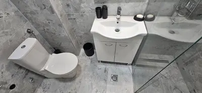a bathroom with a white toilet and a sink at ROYAL Residences in Cetinje