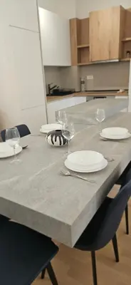 a table with plates and wine glasses on it at ROYAL Residences in Cetinje