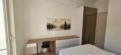 a bedroom with a bed and a desk on the wall at ROYAL Residences in Cetinje