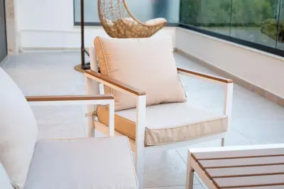 two chairs and a table in a room at sea and sun luxury apartment in Ulcinj