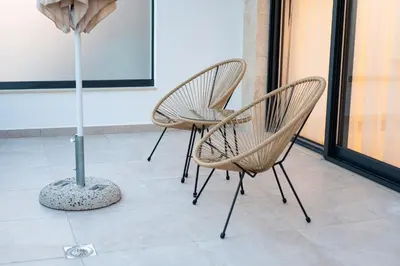 a couple of chairs and a table in a room at sea and sun luxury apartment in Ulcinj