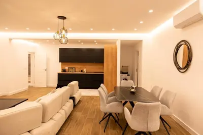 a living room with a couch and a table and chairs at sea and sun luxury apartment in Ulcinj