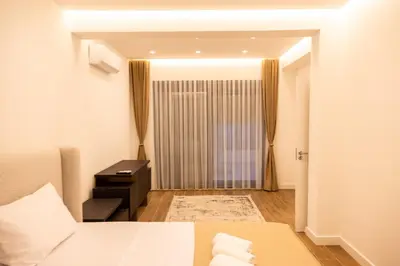 a hotel room with a bed and a window at sea and sun luxury apartment in Ulcinj