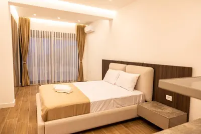 a small bedroom with a bed and a sink at sea and sun luxury apartment in Ulcinj