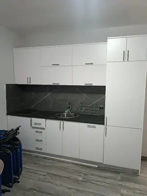 a kitchen with white cabinets and a sink at Infinite Sunset in Ulcinj