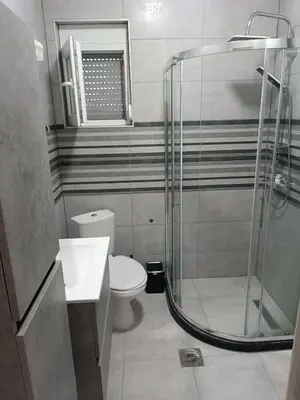 a bathroom with a toilet and a glass shower at Infinite Sunset in Ulcinj