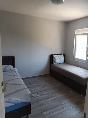 a small bedroom with a bed and a window at Infinite Sunset in Ulcinj