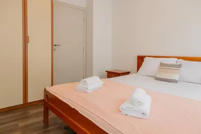 a bedroom with a bed with two towels on it at Bay View Apartment in Kotor