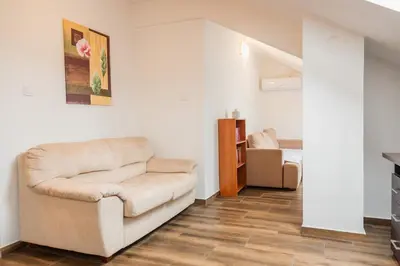 a living room with a couch and a bedroom at Bay View Apartment in Kotor