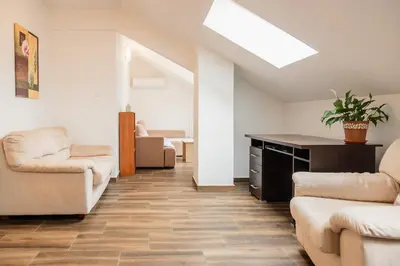 a living room with a couch and chairs and a table at Bay View Apartment in Kotor