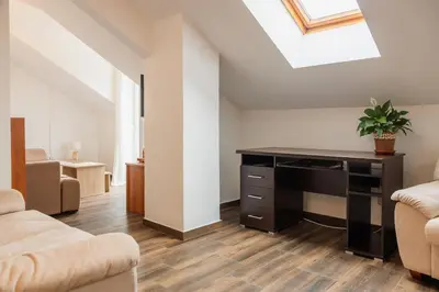 a living room with a desk and a skylight at Bay View Apartment in Kotor