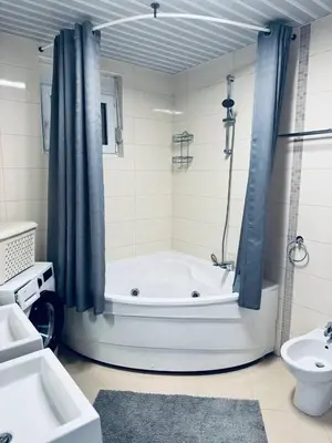 a bathroom with a tub and a sink and a toilet at SF Apartments Lux in Dobra Voda
