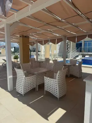a patio with a table and chairs under a pavilion at SF Apartments Lux in Dobra Voda
