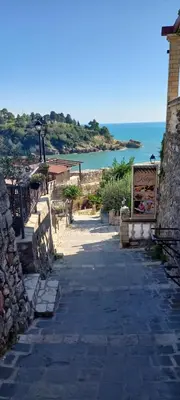 a stone walkway with a view of the ocean at Villa DUDA rooms in Velika Plaža