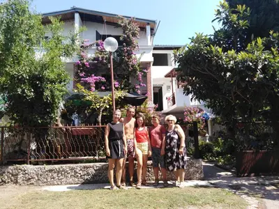 a group of people standing in front of a house at Villa DUDA rooms in Velika Plaža