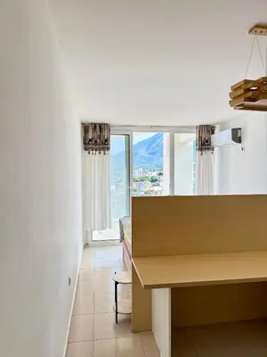 a kitchen with a desk and a large window at Hladna Uvala Minimalist 2 Bedroom Apartman in Bar