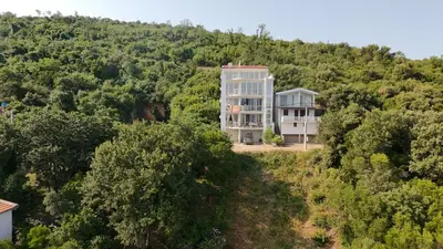 an aerial view of a large house on a hill at Hladna Uvala Minimalist 2 Bedroom Apartman in Bar