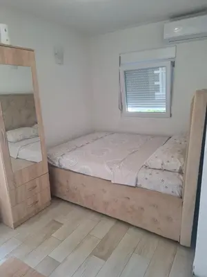 a bedroom with a bed and a mirror at Apartman Ratko in Budva