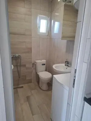 a small bathroom with a toilet and a sink at Apartman Ratko in Budva
