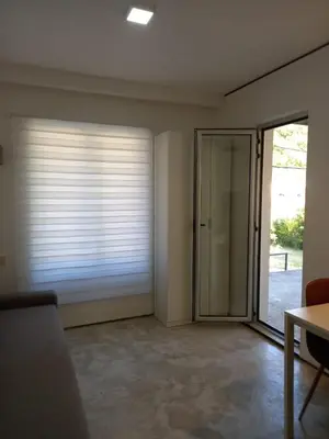 a living room with a sliding glass door at Markovići Studio