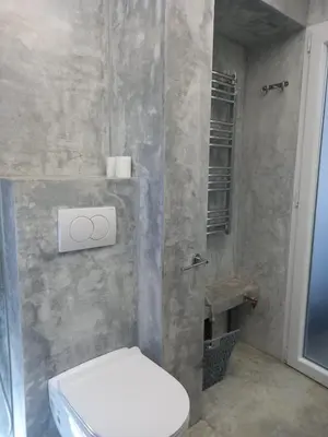 a bathroom with a white toilet and a shower at Markovići Studio