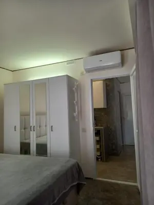 a bedroom with a bed and a large mirror at Markovići Studio