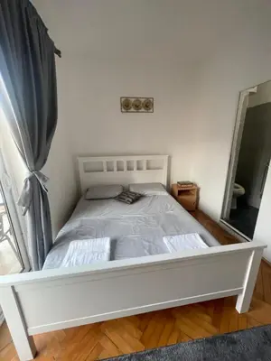 a white bed in a room with a window at Sun & Sea in Ulcinj