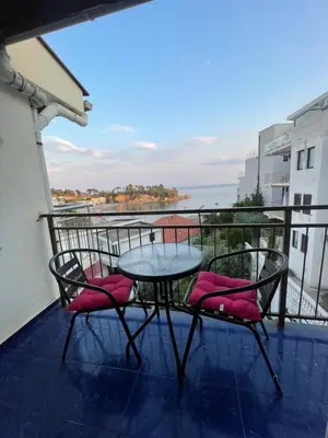 a table and chairs on a balcony with a view of the water at Sun & Sea in Ulcinj