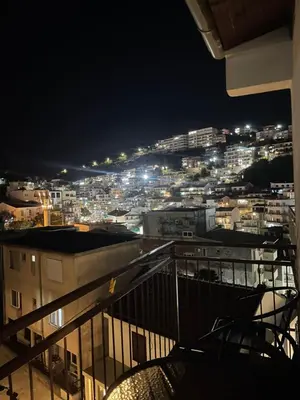 a view of a city at night from a balcony at Sun & Sea in Ulcinj