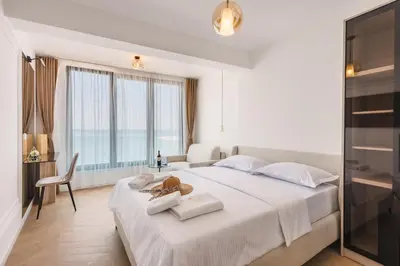 a hotel room with a large bed with towels on it at Hotel Navis in Ulcinj