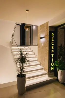 a staircase in a building with two potted plants at Hotel Navis in Ulcinj